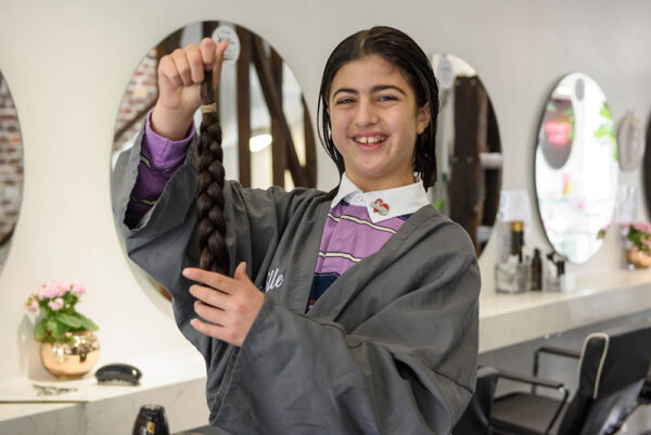 11-Year-old cuts hair at Neville Salon To raise funds for Chain of Hope